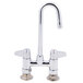 A chrome Equip by T&S deck-mounted faucet with a gooseneck spout and two lever handles.