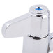 A chrome Equip by T&S deck-mounted faucet with two blue lever handles.