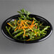 A black Genpak foam bowl filled with green beans and carrots.