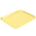 A yellow Cambro Camlite tray on a white background.