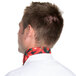 A man wearing an Intedge chili pepper patterned chef neckerchief with a red pepper on it over a white shirt.
