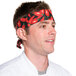 A man wearing a red and green chili pepper patterned chef neckerchief.