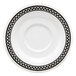 A white saucer with black and white diamond checkered design.