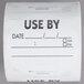 A roll of white paper National Checking Company Use By labels with black text.