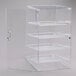 A clear glass Cal-Mil pastry display case with four shelves.
