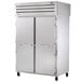 A white True Spec Series reach-in refrigerator with a solid front door and a glass back door.