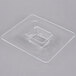 A clear square plastic lid with a square hole in it.