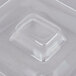 A clear plastic lid for a square food container with a square hole.