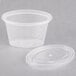 A clear plastic Newspring oval souffle container with a lid.
