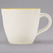 A CAC ivory china espresso cup with a gold rim.