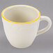A CAC ivory espresso cup with a scalloped edge and gold trim.