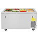 A Turbo Air refrigerated buffet display table with a large container of fruits and vegetables.