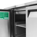 A Turbo Air stainless steel refrigerated buffet display table with a green door.