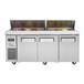 A Turbo Air 3 door refrigerated sandwich prep table with food in it.