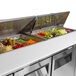 A Turbo Air stainless steel refrigerated sandwich prep table with food in containers.