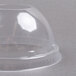 A clear plastic container with a Dart clear plastic dome lid.