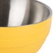 A Vollrath Nugget Yellow metal serving bowl with a stainless steel handle.