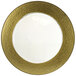 A gold charger plate with a white rim.
