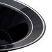 A close-up of a Fineline black plastic soup bowl with silver bands.