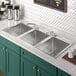 A Regency stainless steel drop-in sink with three compartments.