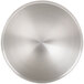 A close-up of a circular stainless steel surface with a satin finish.