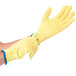 A pair of small yellow Cordova cut resistant gloves with blue trim on the wrists.