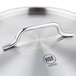 A Vollrath stainless steel pan cover with a metal handle.