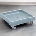 A slate blue plastic dolly with wheels.