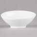 An Arcoroc white porcelain bowl with a small rim.