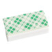 A white rectangular Scotsman curtain magnet with green and white designs.