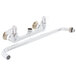 A white Equip by T&S wall mount faucet with 8" adjustable centers and lever handles.