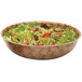 A dark Cambro basketweave fiberglass bowl filled with salad, tomatoes, and lettuce.