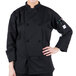 A person wearing a black Mercer Culinary chef coat.