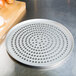 An American Metalcraft Super Perforated Pizza Pan with a metal tray with holes on it.