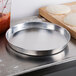 An American Metalcraft heavy weight aluminum pizza pan on a counter.
