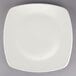 A Tuxton square china plate with a white rim on a gray background.