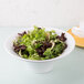 An American Metalcraft flared round melamine bowl filled with salad with lettuce and a fork.