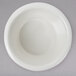 A white Thunder Group fluted ramekin in a white bowl.