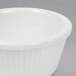 A white Thunder Group melamine ramekin with fluted edges on a gray background.