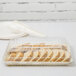 A Fineline ivory plastic rectangular tray with sliced bread in it.