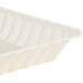 A white plastic rectangular tray with scalloped edges.