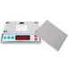 A silver Cardinal Detecto digital portion scale with red buttons and a square cover.