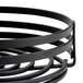 An American Metalcraft black wrought iron condiment caddy with four rings on a counter.