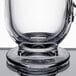 A Libbey clear glass coffee mug with a handle on a reflective surface.
