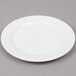 An Arcoroc white porcelain salad plate with a small rim.