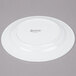 A white Arcoroc porcelain salad plate with black text reading "Arcoroc"
