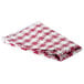 A folded red and white checkered vinyl table cover.