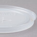 A close up of a translucent plastic Cambro lid with a straw slot.