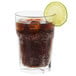 A Libbey Gibraltar beverage glass of soda with ice and a lime slice.