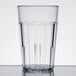 A close-up of a clear Cambro plastic tumbler with a black rim.